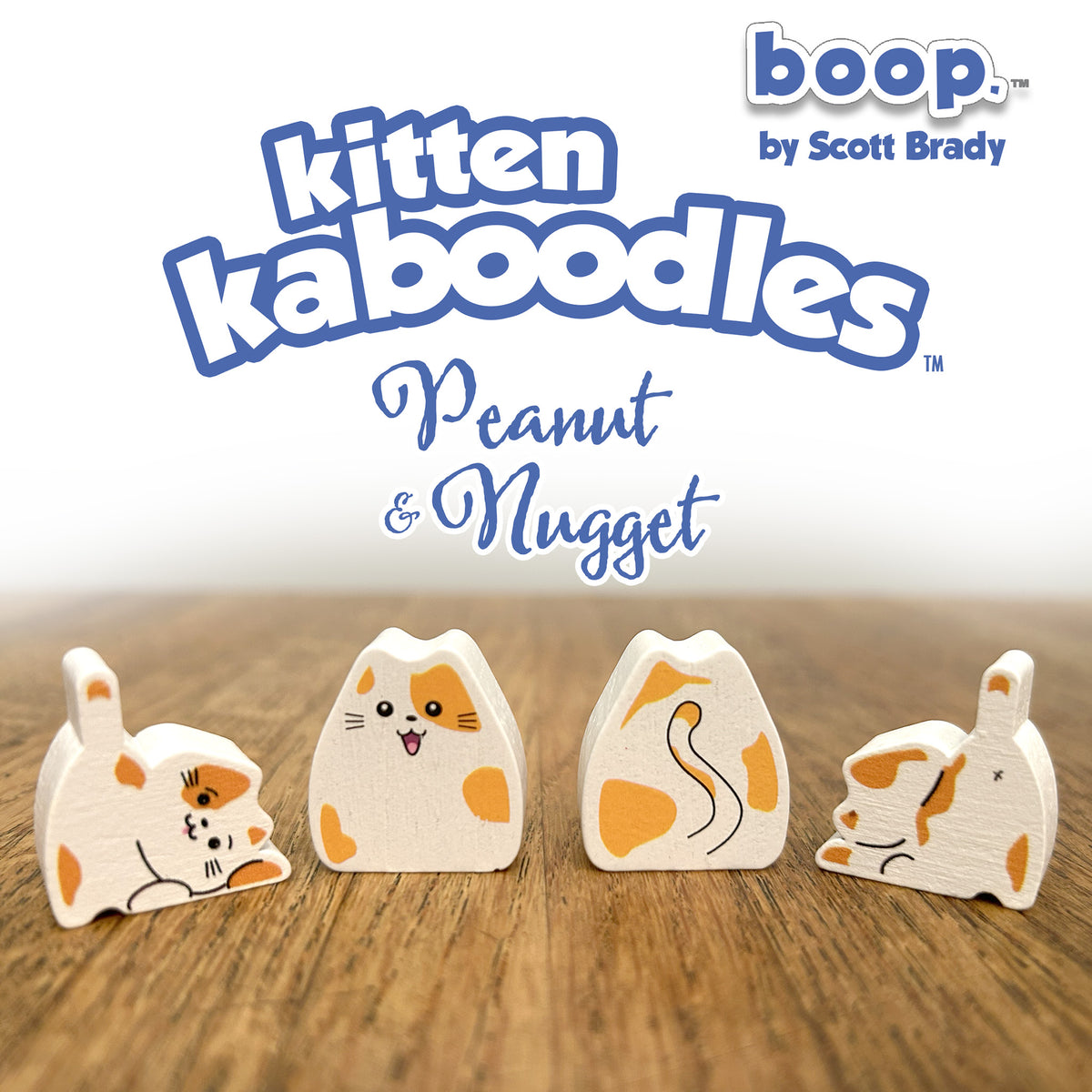 Wooden toy figures of a cat with 'boop' branding on a wooden surface.